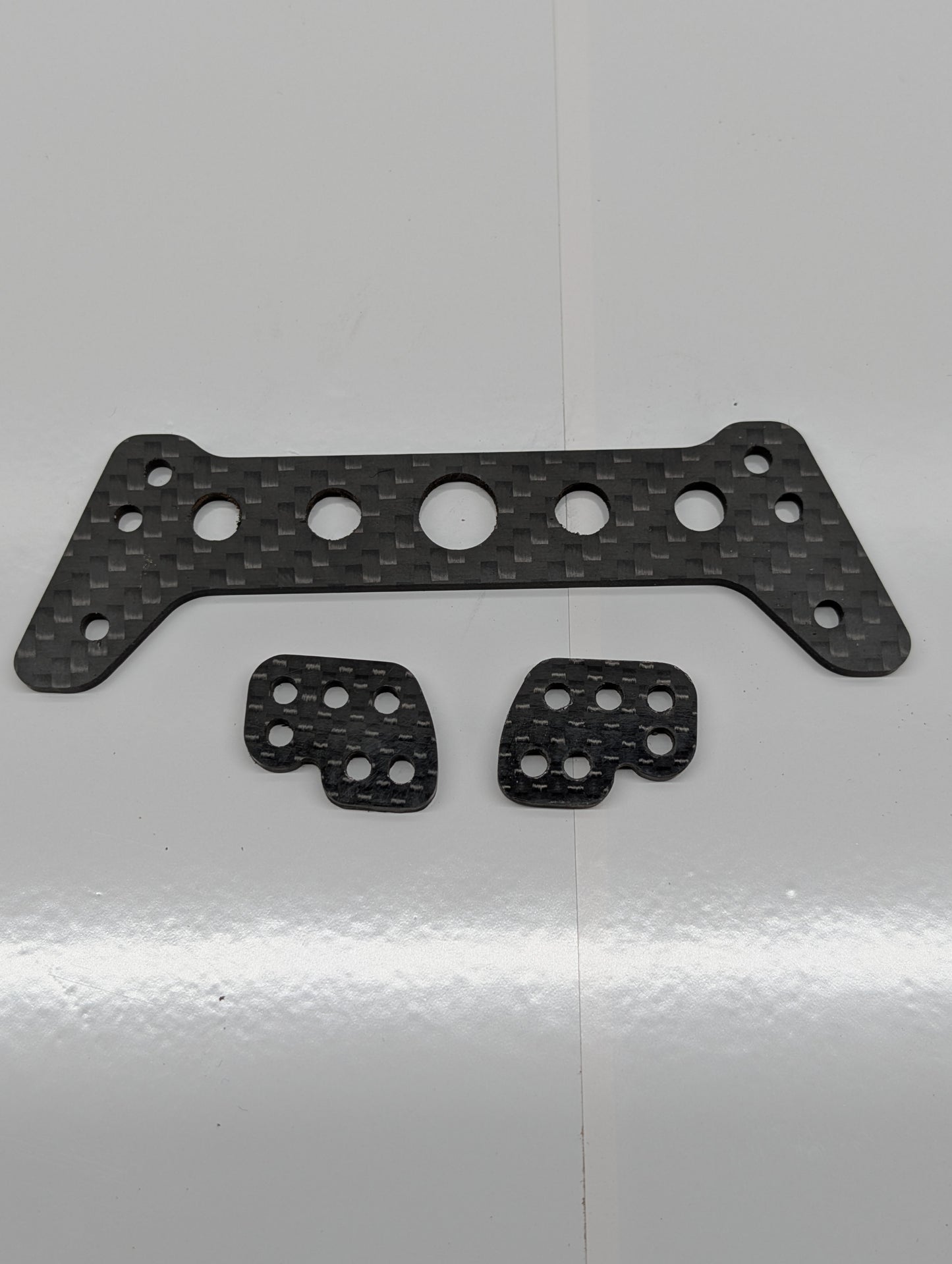 H10 Shock relocation bracket. Carbon fiber.