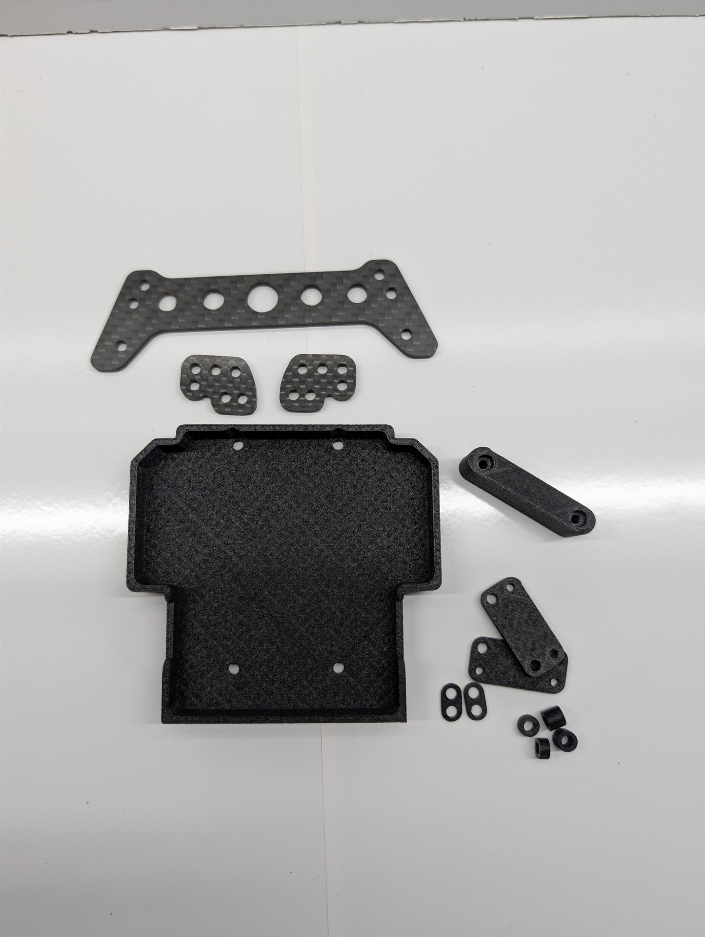 H10 Shock relocation bracket. Carbon fiber.